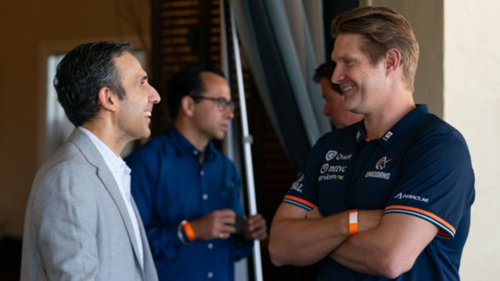 Zee Zaidi and Shane Watson share a conversation during the Cricket Impact Lunch 2025, highlighting networking and collaboration in the cricket community.
